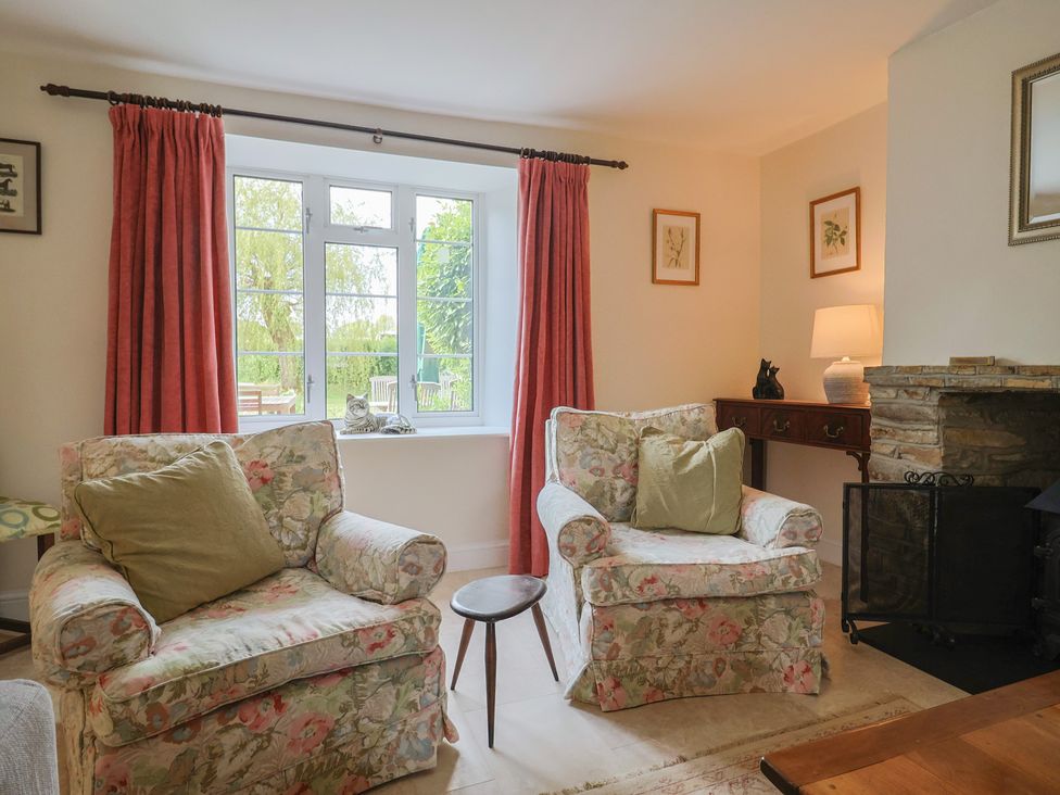 A living room with floral sofas and a lamp at Harbins Farm Glanvilles Wootton Nr. Sherborne