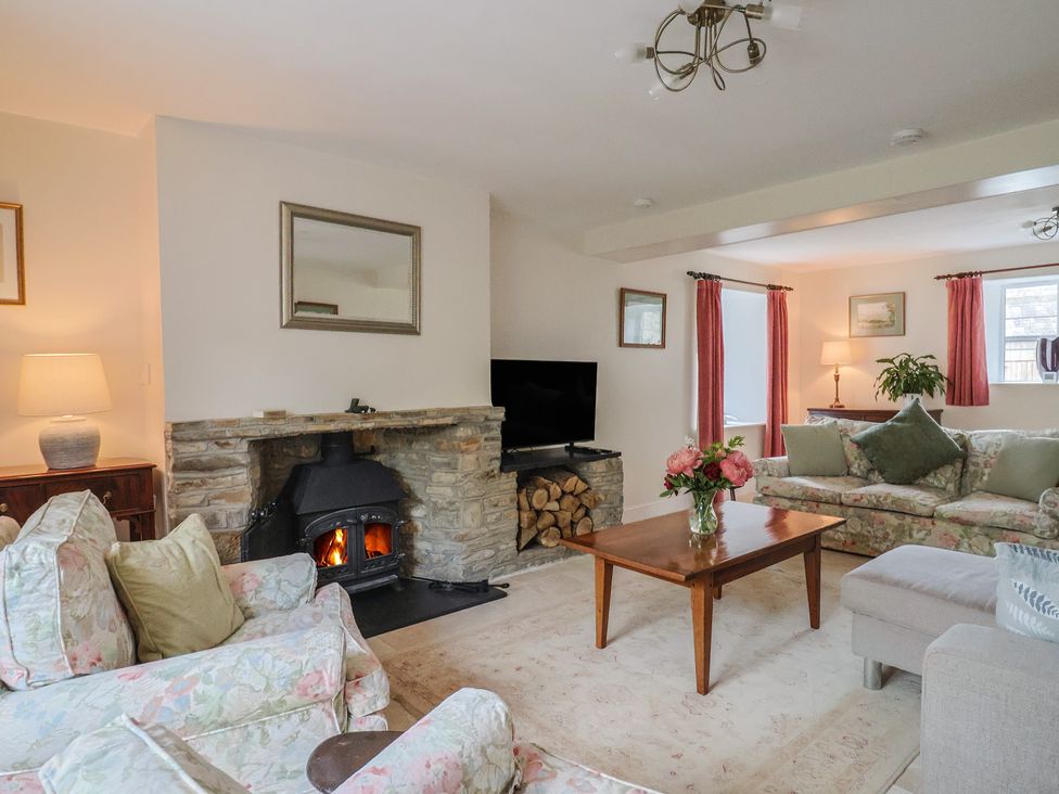 A living room with a fireplace and sofa at Harbins Farm, Glanvilles Wootton Nr. Sherborne