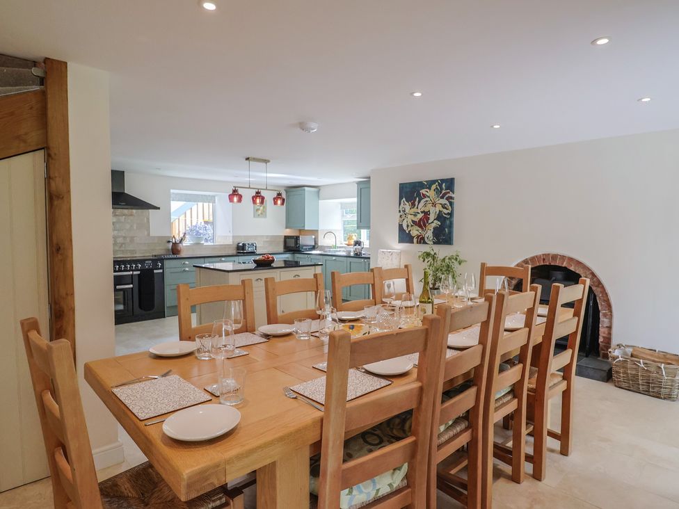 A dining room with a large table and kitchen in Harbins Farm Glanvilles Wootton Nr. Sherborne
