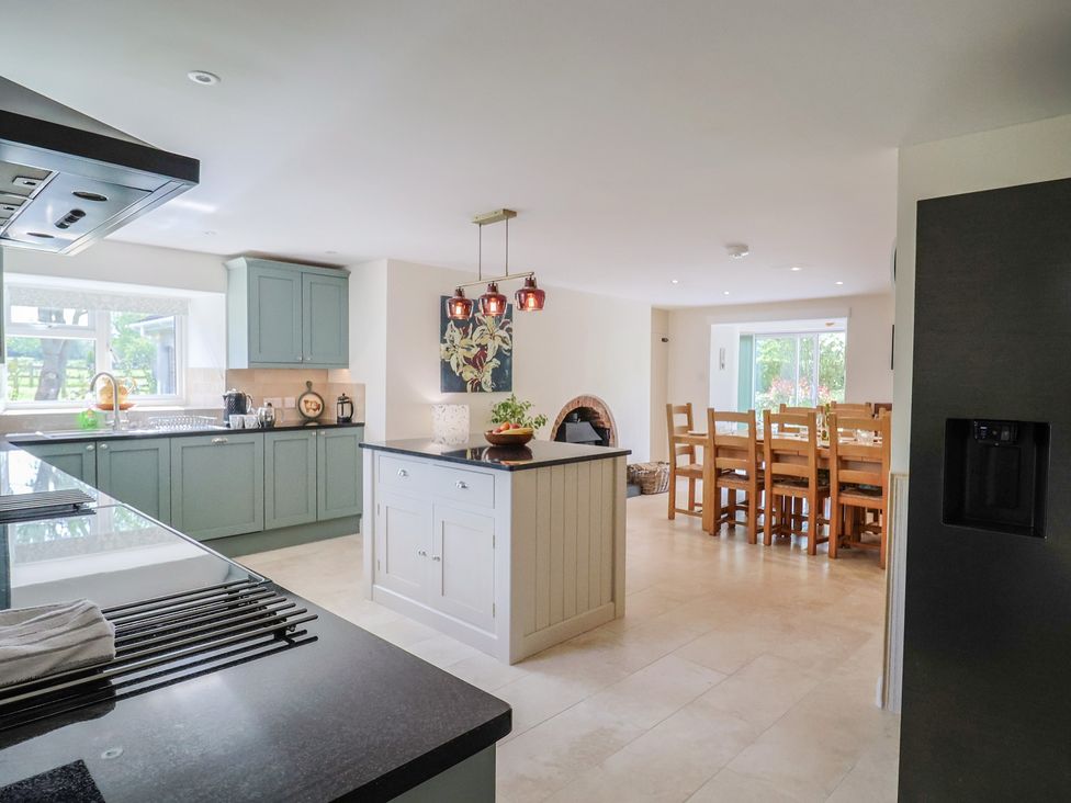 A kitchen with cabinets and dining area at Harbins Farm Glanvilles Wootton Nr. Sherborne