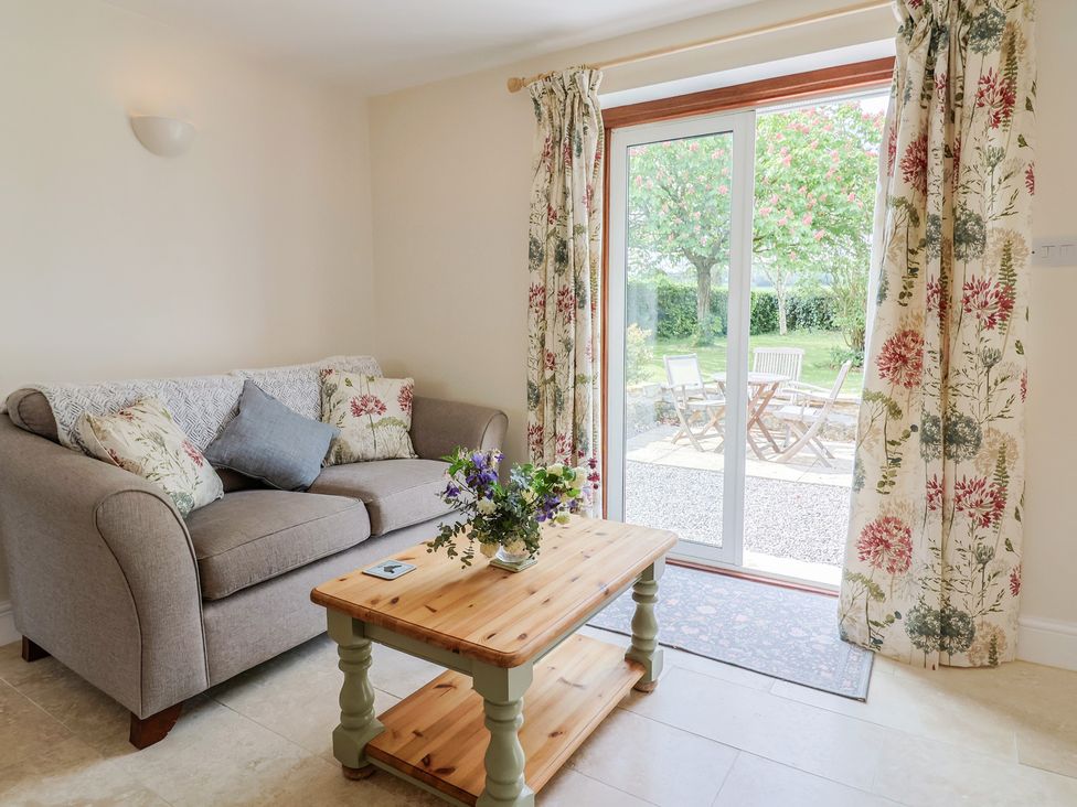 A living room with a sofa and coffee table at Harbins Farm Glanvilles Wootton Nr. Sherborne