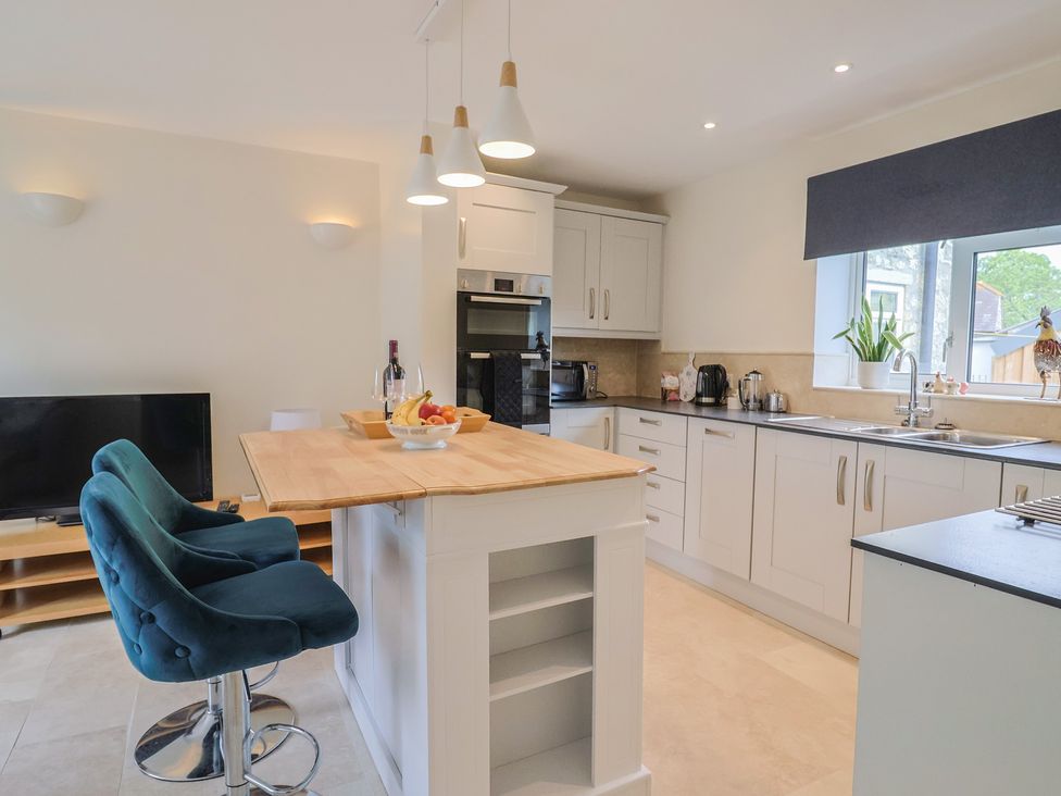 A kitchen with a breakfast bar and appliances at Harbins Farm Glanvilles Wootton Nr. Sherborne