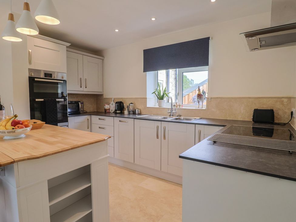 A kitchen with cabinets and appliances at Harbins Farm in Glanvilles Wootton Nr. Sherborne