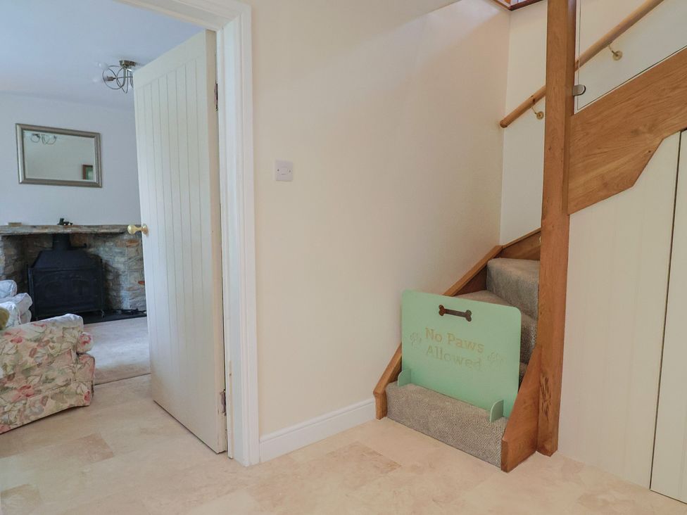 A hallway with a staircase and a sign at Harbins Farm in Glanvilles Wootton Nr. Sherborne