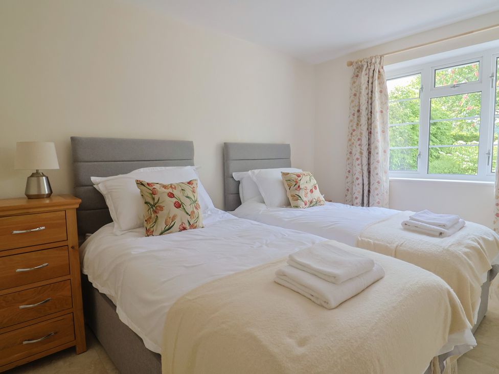 A bedroom with two single beds and a dresser at Harbins Farm, Glanvilles Wootton Nr. Sherborne