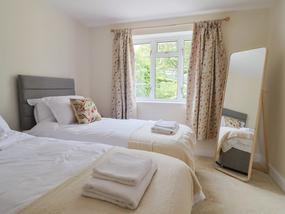 A bedroom with two beds and a mirror at Harbins Farm Glanvilles Wootton Nr. Sherborne