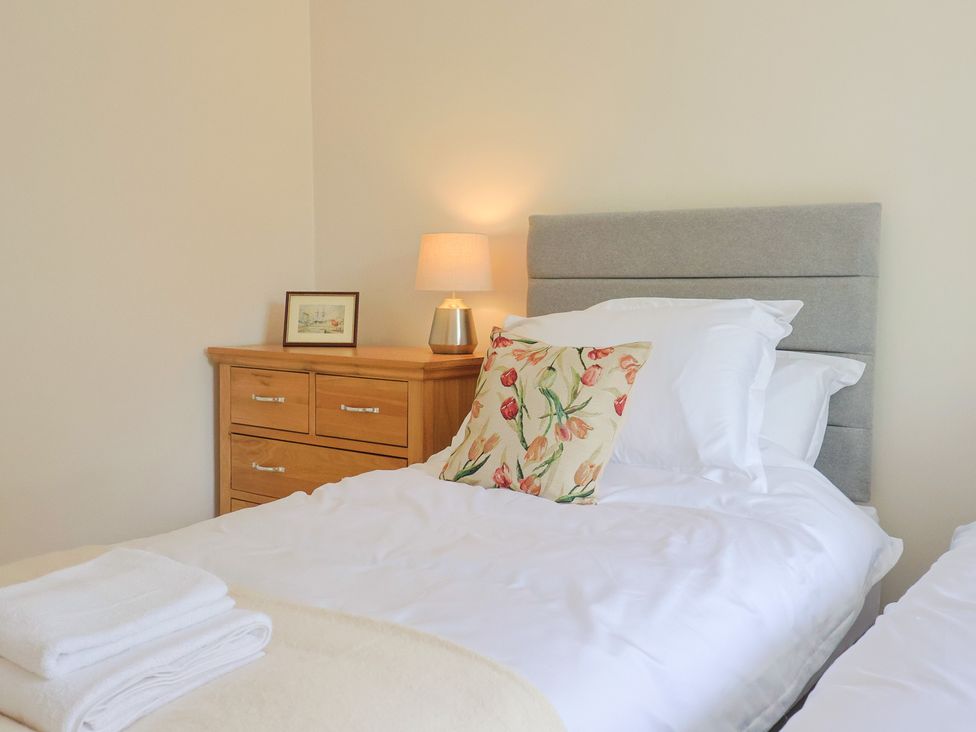 A bedroom with two beds and a lamp on the dressing table at Harbins Farm Glanvilles Wootton Nr. Sherborne
