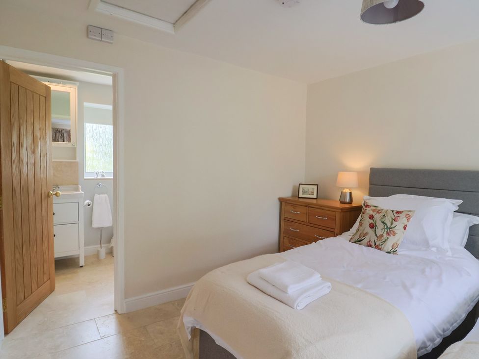 A bedroom with a bed and bedside table at Harbins Farm in Glanvilles Wootton Nr. Sherborne