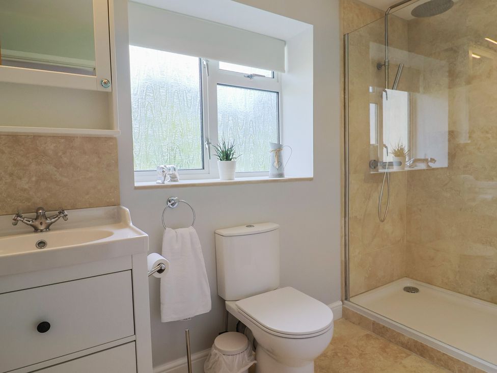 A bathroom with a shower and sink at Harbins Farm Glanvilles Wootton Nr. Sherborne