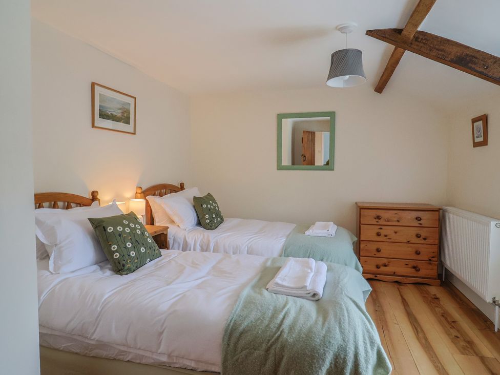 A bedroom with two beds and a dresser at Harbins Farm, Glanvilles Wootton Nr. Sherborne