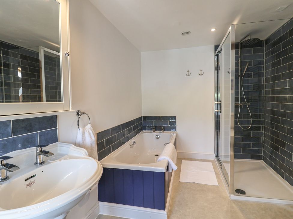 A bathroom with a bathtub and shower at Harbins Farm Glanvilles Wootton Nr. Sherborne