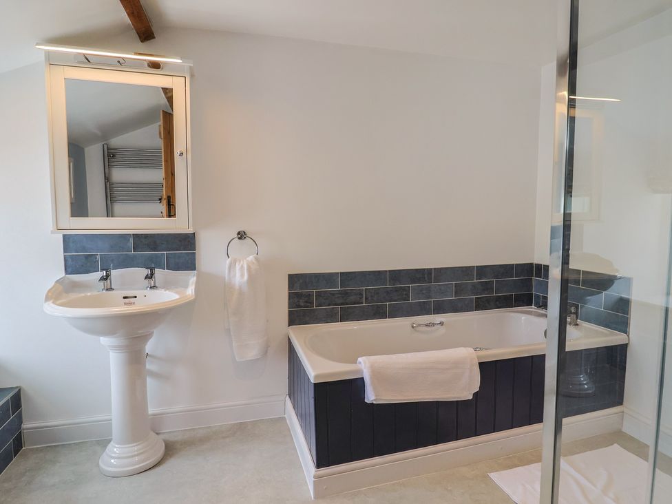A bathroom with a bathtub and wash basin at Harbins Farm Glanvilles Wootton Nr. Sherborne