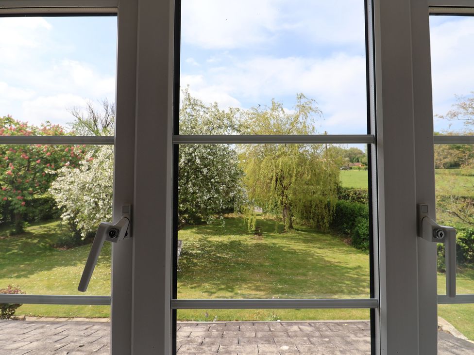 A view of a garden with trees and grass at Harbins Farm Glanvilles Wootton Nr. Sherborne