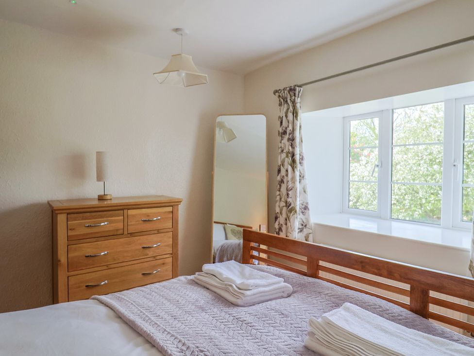 A bedroom with a bed and dresser at Harbins Farm in Glanvilles Wootton Nr. Sherborne