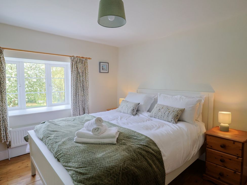A bedroom with a bed and lamp at Harbins Farm Glanvilles Wootton Nr. Sherborne