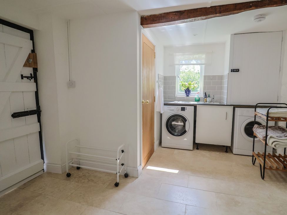 A laundry room with washing machine and drying rack at Harbins Farm in Glanvilles Wootton Nr. Sherborne