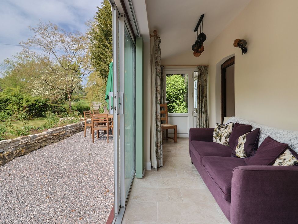 A conservatory with a sofa and chairs at Harbins Farm Glanvilles Wootton Nr. Sherborne