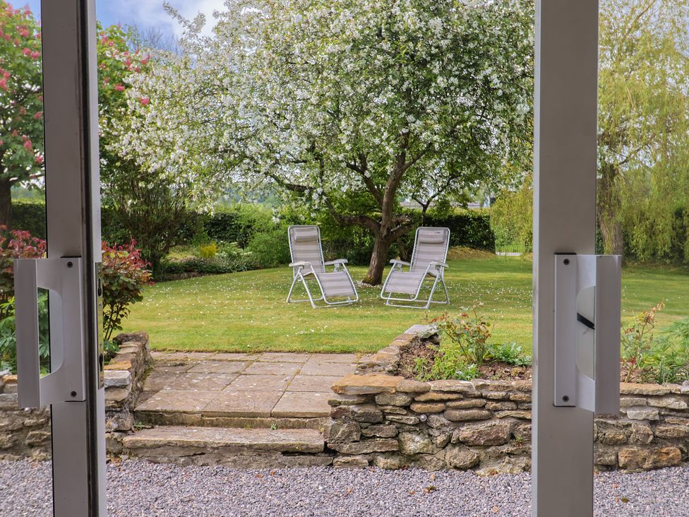 A garden with two deck chairs and a tree at Harbins Farm Glanvilles Wootton Nr. Sherborne