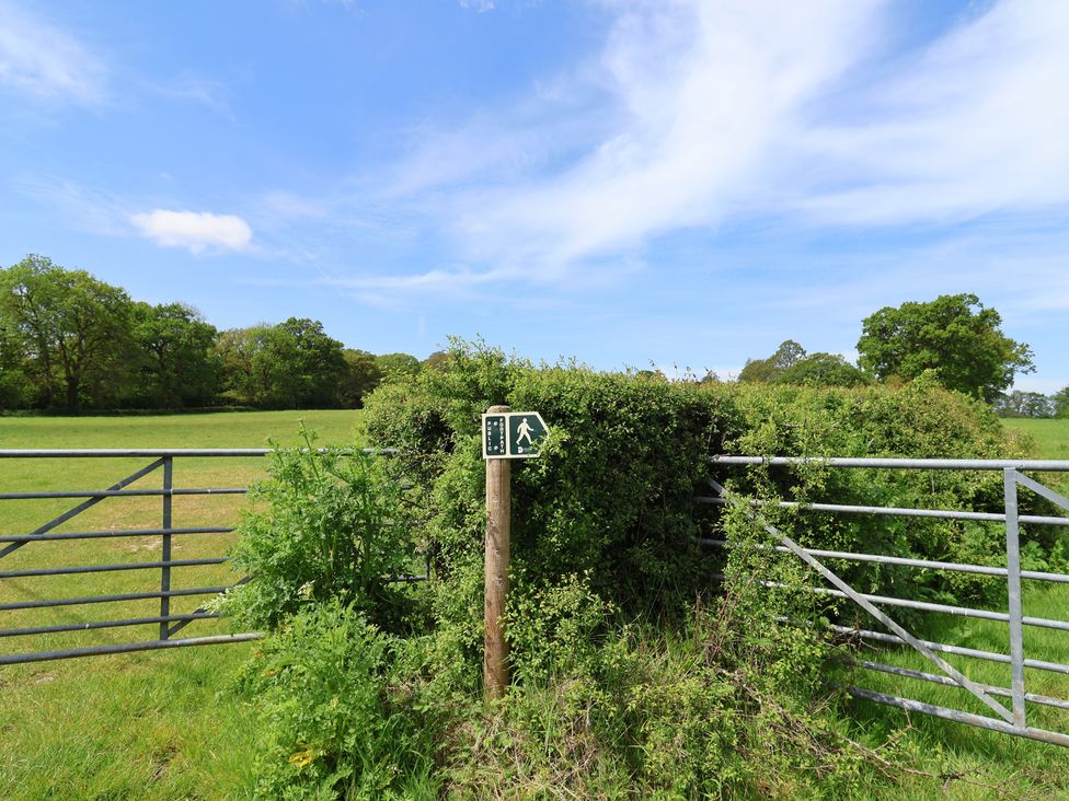 A gate with a walking sign in a grassy field at Harbins Farm Glanvilles Wootton Nr. Sherborne