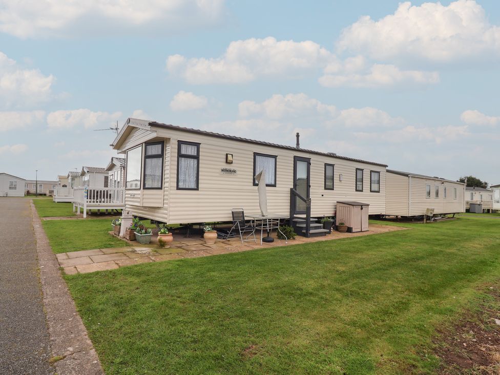 A mobile home with steps and outdoor chairs at Winchester - 244