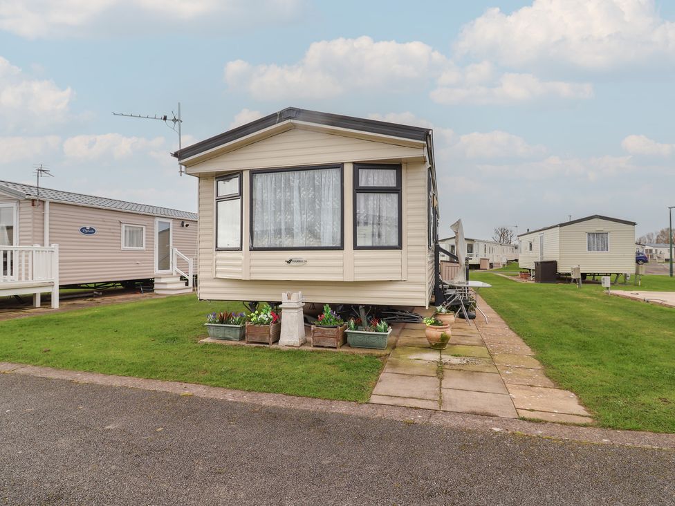 A caravan with plants in pots beside it at Winchester - 244