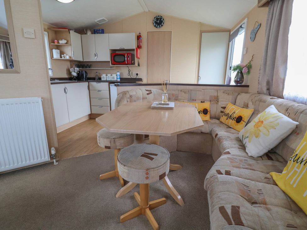 A kitchen with a table and sofa at Winchester - 244