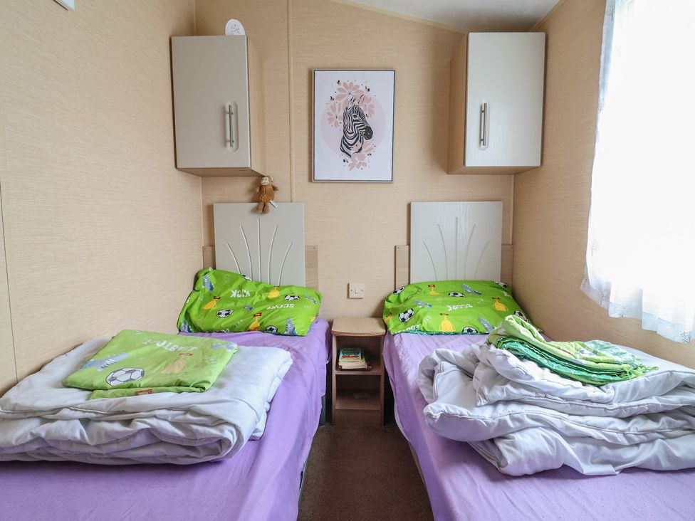 A bedroom with two beds and a nightstand at Winchester - 244