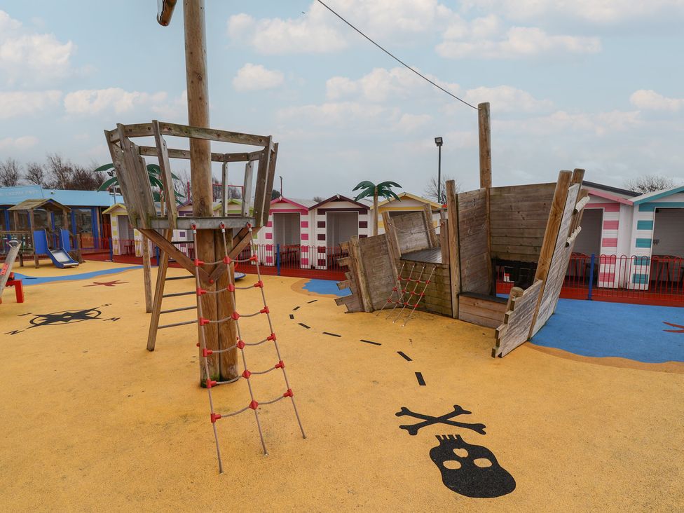 A playground with climbing equipment and themed ground markings at Winchester - 244