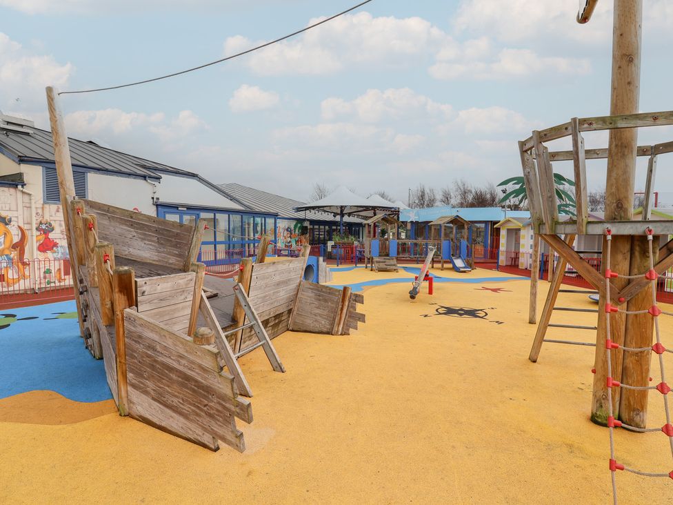 A playground with a wooden ship and climbing frame at Winchester - 244