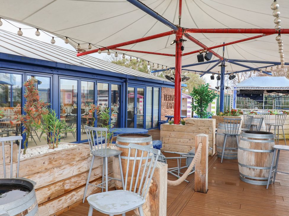 An outdoor seating area with wooden barrels and tables at Winchester - 244