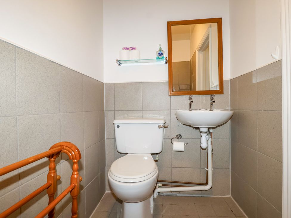 A bathroom with a toilet and sink at Linhay Barn in Callington