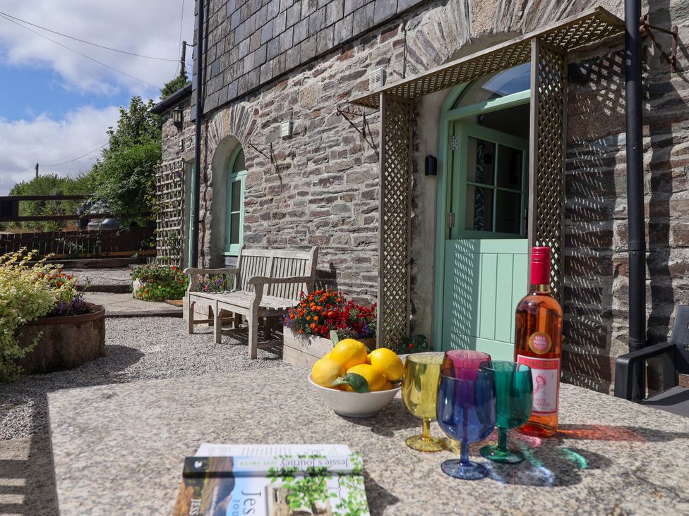 An outdoor area with a bench and table at Linhay Barn Callington