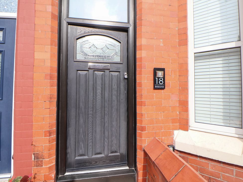 An entryway with a black door and number 18 at Seaside Home New Brighton