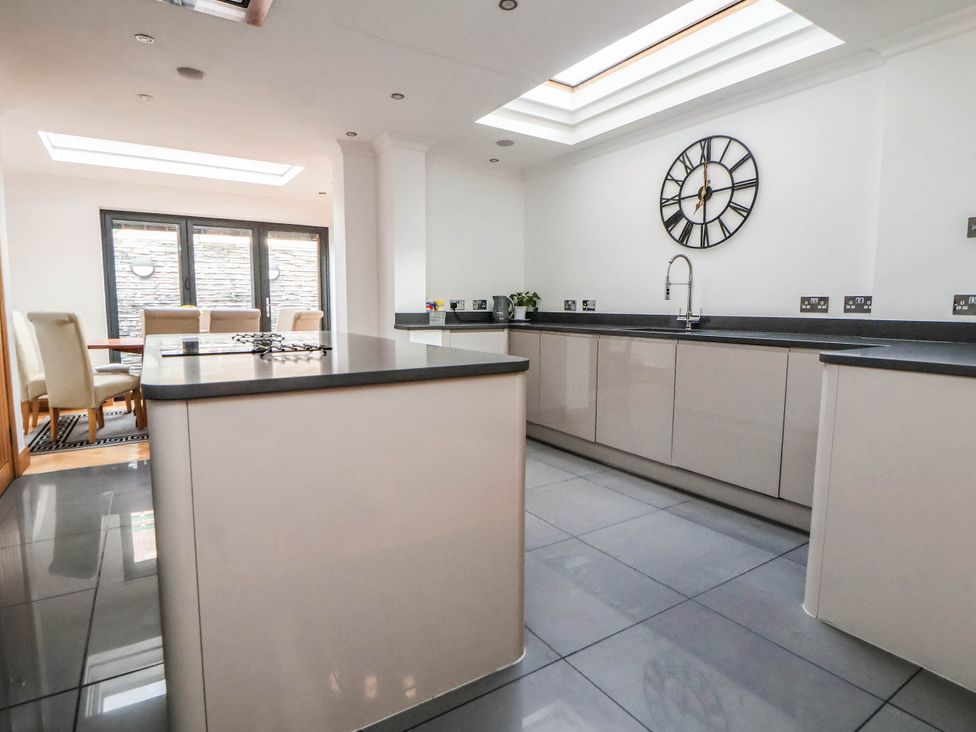 A kitchen with an island and dining area at Seaside Home in New Brighton