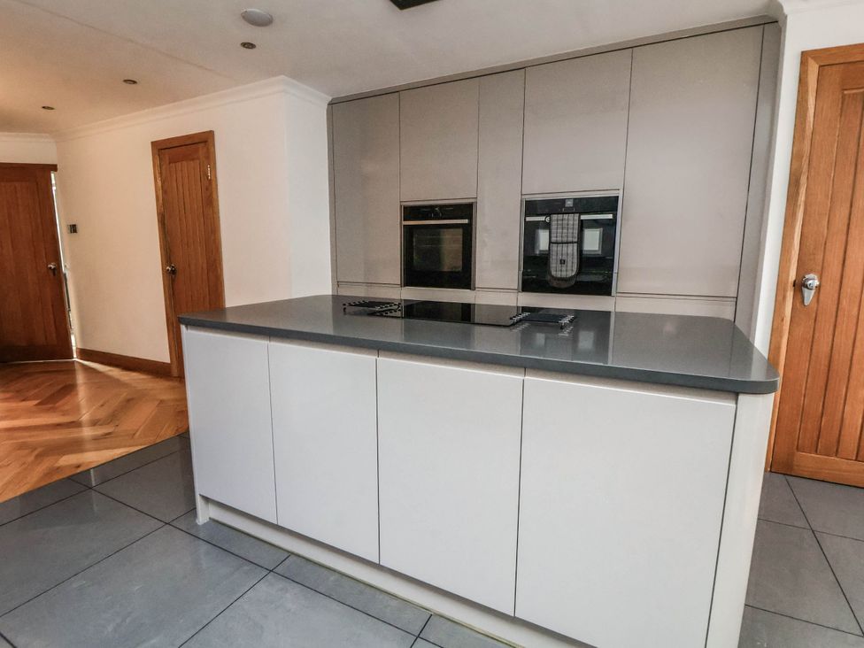 A kitchen with a kitchen island and built-in ovens at Seaside Home in New Brighton