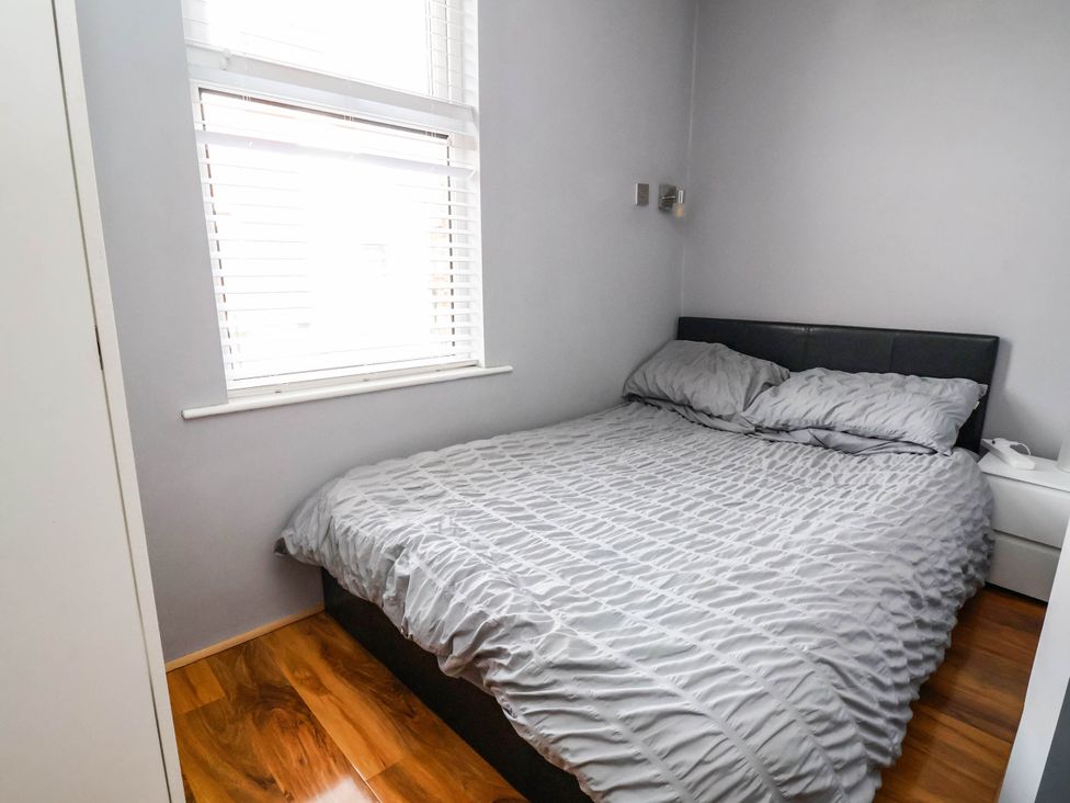 A bedroom with a bed and window at Seaside Home in New Brighton
