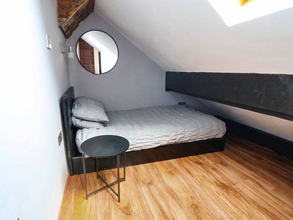 A bedroom with a bed and nightstand at Seaside Home in New Brighton