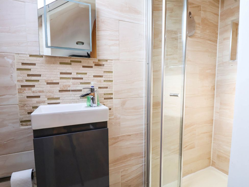 A bathroom with a sink and shower at Seaside Home in New Brighton