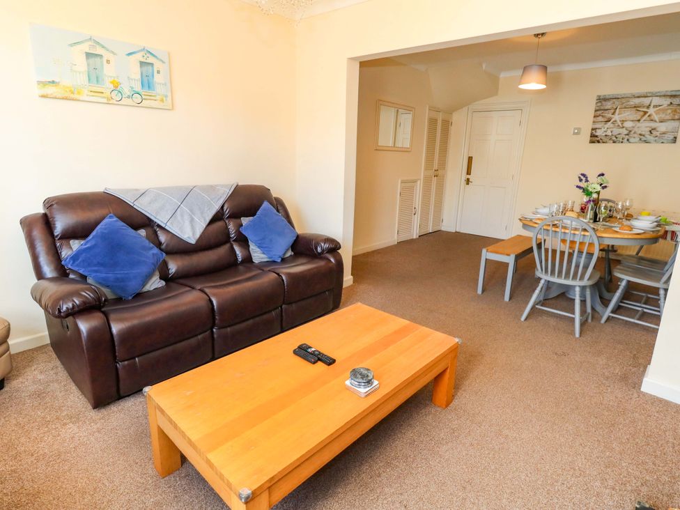 A living room with a sofa and dining area at Home from Home near the Sea in Weymouth
