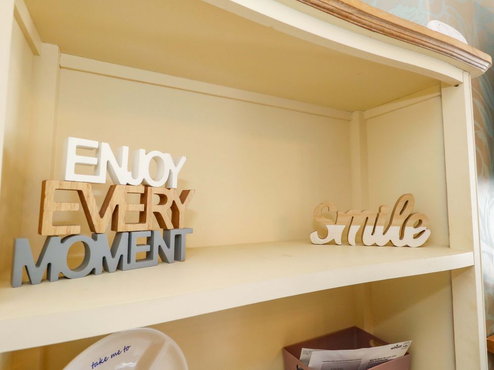 A shelf with decorative words at Home from Home near the Sea in Weymouth