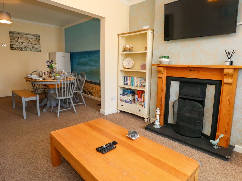 A living room with a dining area and furniture at Home from Home near the Sea Weymouth