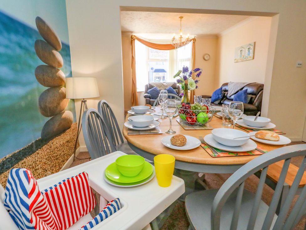 A dining room with a table set for dinner at Home from Home near the Sea in Weymouth
