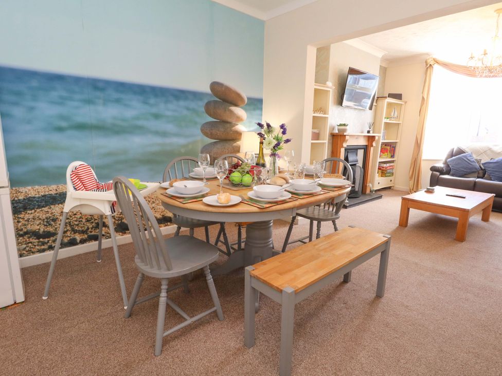 A dining area with a table set for meals at Home from Home near the Sea in Weymouth