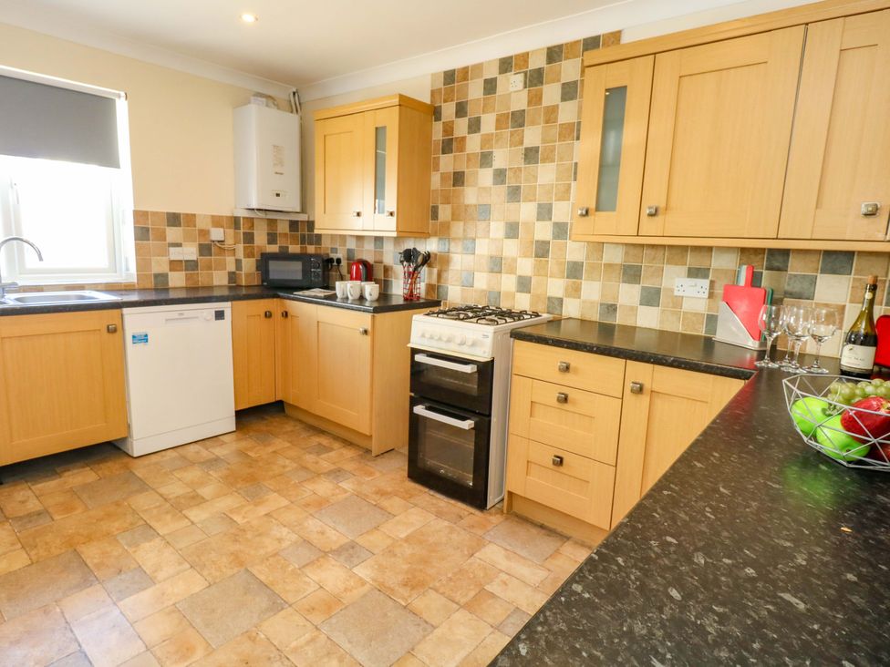 A kitchen with appliances and cabinets at Home from Home near the Sea Weymouth