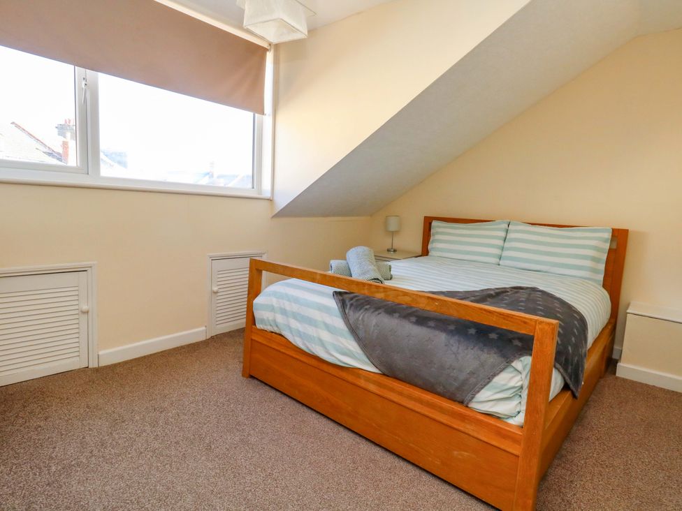 A bedroom with a bed and a lamp at Home from Home near the Sea in Weymouth