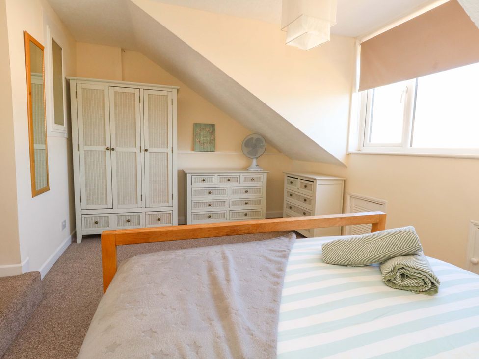 A bedroom with a bed and storage furniture at Home from Home near the Sea Weymouth