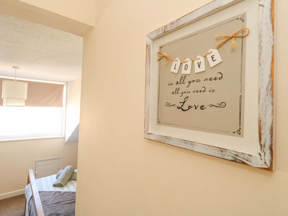 A bedroom with a framed picture on the wall at Home from Home near the Sea Weymouth