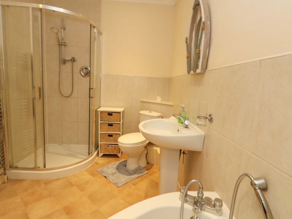 A bathroom with shower, toilet, and sink at Home from Home near the Sea Weymouth