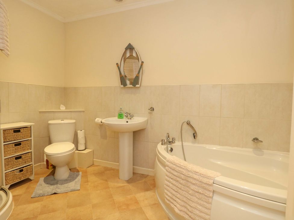 A bathroom with a sink, toilet and bathtub at Home from Home near the Sea Weymouth