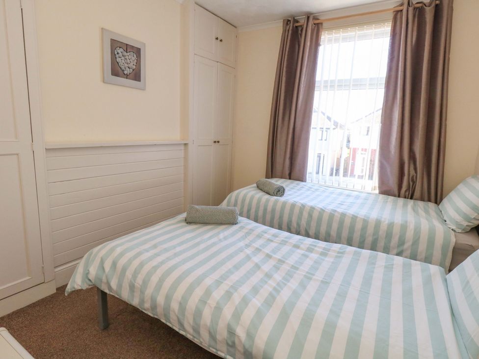 A bedroom with two beds and a window at Home from Home near the Sea Weymouth